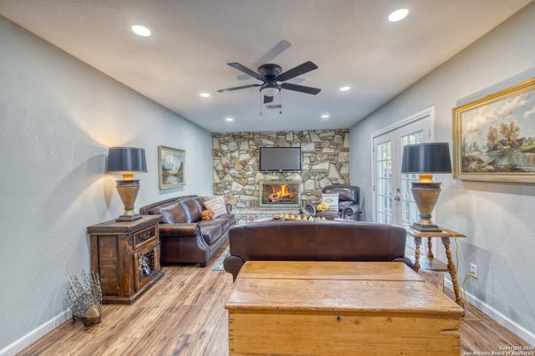 Fireplace, Interior, Living room, Recessed Lighting, Stone Walls, Wood Texture Flooring