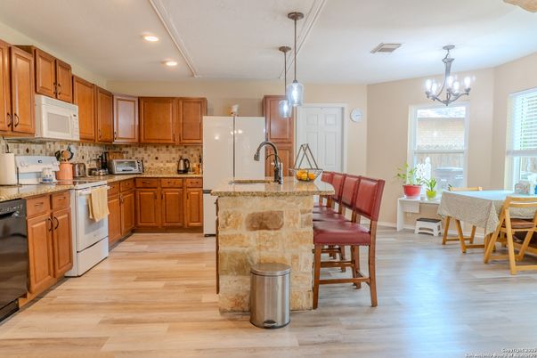 Chandelier, Dining room, Interior, Kitchen, Pendant Lights, Recessed Lighting, Stainless Steel Appliances, Wood Texture Flooring