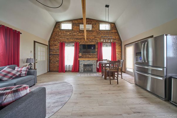 Dining room, Fireplace, Interior, Kitchen, Living room, Pendant Lights, Stainless Steel Appliances, Stone Walls, Wooden Beams, Wood Texture Flooring
