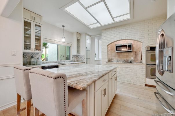 Fireplace, Interior, Kitchen, Pendant Lights, Stainless Steel Appliances, Stone Walls, Wood Texture Flooring