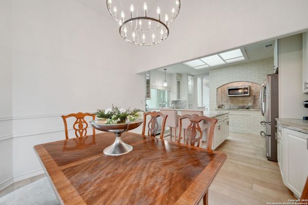 Dining room, Fireplace, Interior, Kitchen, Pendant Lights, Stainless Steel Appliances, Stone Walls, Wood Texture Flooring