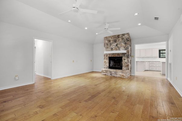 Empty room, Fireplace, Interior, Recessed Lighting, Stone Walls, Wood Texture Flooring