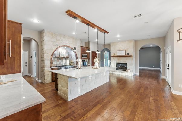 Fireplace, Interior, Kitchen, Pendant Lights, Recessed Lighting, Stone Walls, Wood Texture Flooring