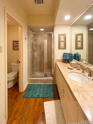 Bathroom, Dual Sink Vanities, Glass Shower, Interior, Recessed Lighting, Tile Countertops, Wood Texture Flooring