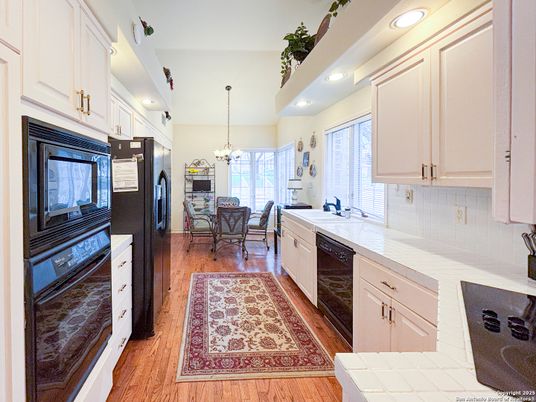 Chandelier, Dining room, Interior, Kitchen, Recessed Lighting, Tile Countertops, Wood Texture Flooring
