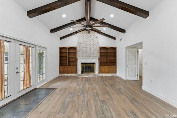 Empty room, Fireplace, Interior, Recessed Lighting, Stone Walls, Wooden Beams, Wood Texture Flooring