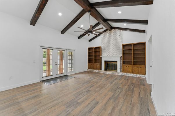 Empty room, Fireplace, Interior, Recessed Lighting, Stone Walls, Wooden Beams, Wood Texture Flooring