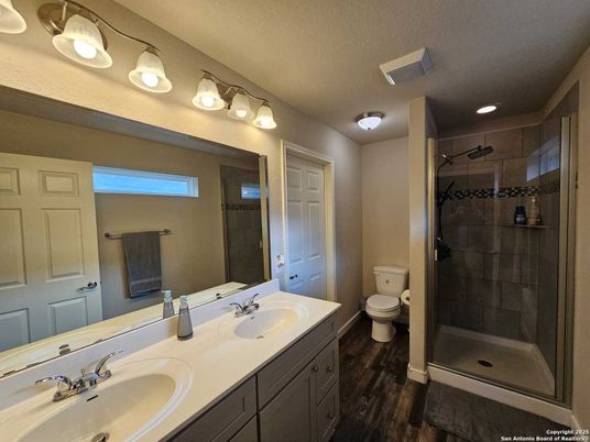 Bathroom, Dual Sink Vanities, Glass Shower, Interior, Recessed Lighting, Wood Texture Flooring