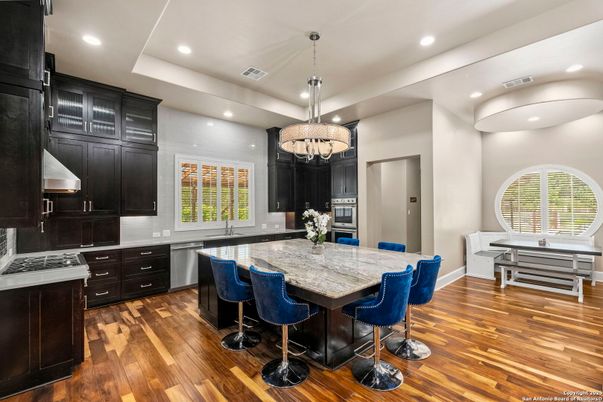 Chandelier, Dining room, Interior, Kitchen, Pendant Lights, Recessed Lighting, Stainless Steel Appliances, Wood Texture Flooring