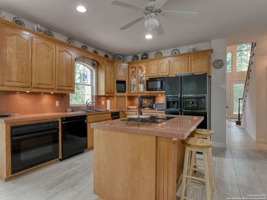Interior, Kitchen, Recessed Lighting, Tile Countertops, Wood Texture Flooring