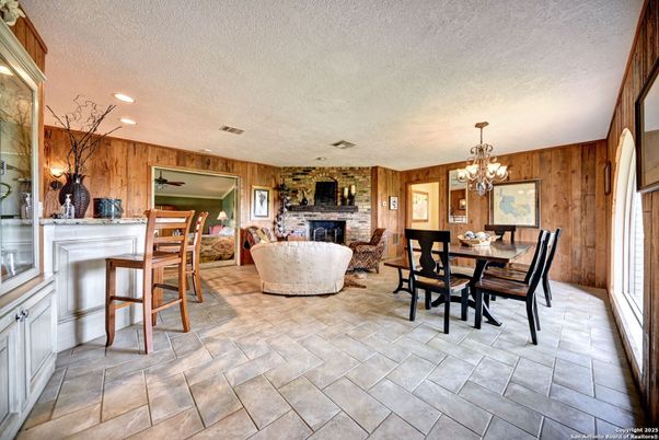 Chandelier, Dining room, Fireplace, Interior, Living room, Recessed Lighting, Stone Walls, Wooden Walls