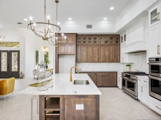 Chandelier, Interior, Kitchen, Marble Walls, Pendant Lights, Recessed Lighting, Stainless Steel Appliances, Wood Texture Flooring