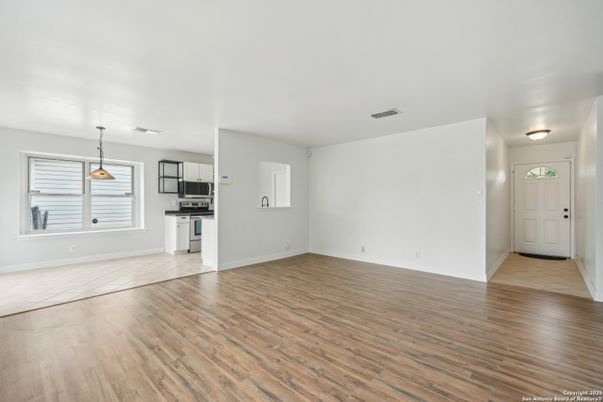 Empty room, Interior, Kitchen, Pendant Lights, Stainless Steel Appliances, Wood Texture Flooring