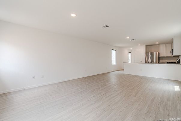 Empty room, Interior, Kitchen, Recessed Lighting, Stainless Steel Appliances, Wood Texture Flooring