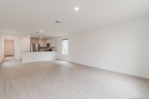 Empty room, Interior, Kitchen, Recessed Lighting, Stainless Steel Appliances, Wood Texture Flooring