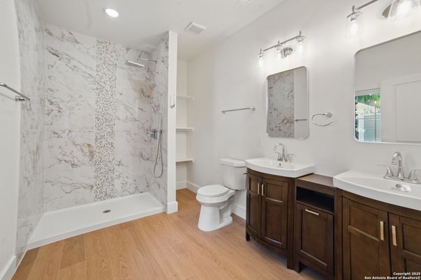 Bathroom, Dual Sink Vanities, Interior, Marble Walls, Recessed Lighting, Wood Texture Flooring