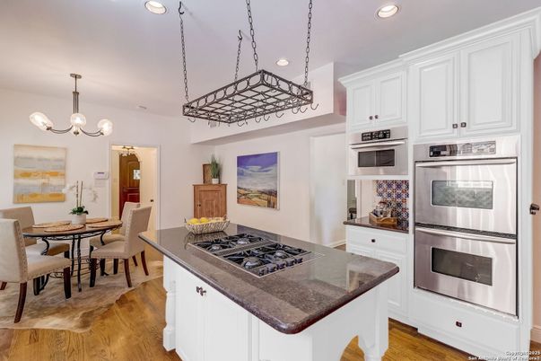 Chandelier, Dining room, Interior, Kitchen, Pendant Lights, Recessed Lighting, Stainless Steel Appliances, Wood Texture Flooring