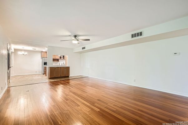 Empty room, Interior, Kitchen, Recessed Lighting, Stainless Steel Appliances, Wood Texture Flooring