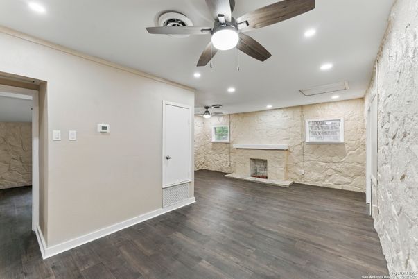Empty room, Fireplace, Interior, Recessed Lighting, Stone Walls, Wood Texture Flooring