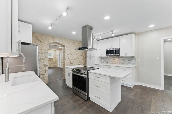 Interior, Kitchen, Marble Walls, Recessed Lighting, Stainless Steel Appliances, Wood Texture Flooring