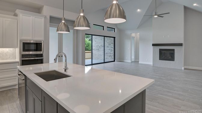 Fireplace, Interior, Kitchen, Pendant Lights, Recessed Lighting, Stainless Steel Appliances, Wood Texture Flooring