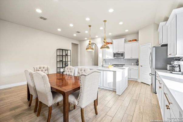 Dining room, Interior, Kitchen, Pendant Lights, Recessed Lighting, Stainless Steel Appliances, Wood Texture Flooring
