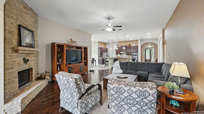 Fireplace, Interior, Kitchen, Living room, Pendant Lights, Recessed Lighting, Stainless Steel Appliances, Stone Walls, Wood Texture Flooring