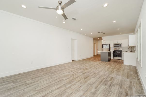 Empty room, Interior, Kitchen, Pendant Lights, Recessed Lighting, Stainless Steel Appliances, Wood Texture Flooring