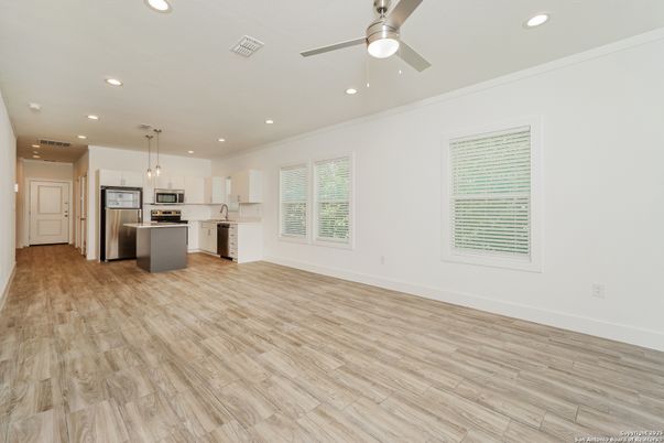 Empty room, Interior, Kitchen, Pendant Lights, Recessed Lighting, Stainless Steel Appliances, Wood Texture Flooring
