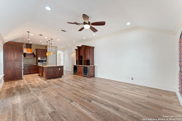 Empty room, Interior, Kitchen, Pendant Lights, Recessed Lighting, Stainless Steel Appliances, Wood Texture Flooring