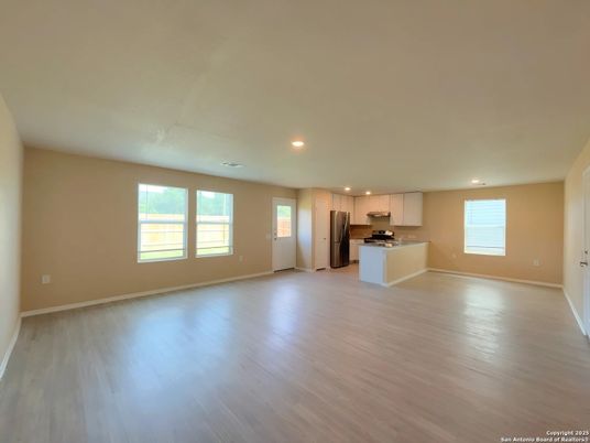 Empty room, Interior, Kitchen, Recessed Lighting, Stainless Steel Appliances, Wood Texture Flooring