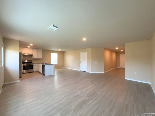 Empty room, Interior, Kitchen, Recessed Lighting, Stainless Steel Appliances, Wood Texture Flooring