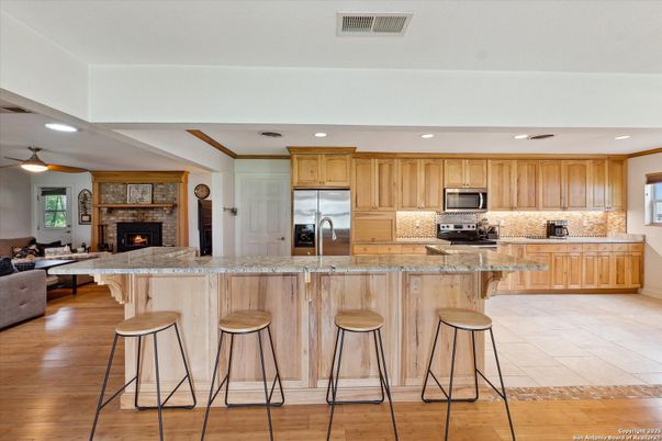 Fireplace, Interior, Kitchen, Living room, Recessed Lighting, Stainless Steel Appliances, Wood Texture Flooring