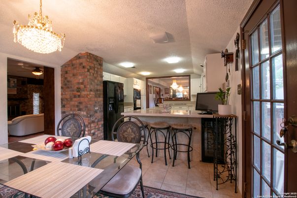 Chandelier, Dining room, Fireplace, Interior, Kitchen, Recessed Lighting, Stone Walls