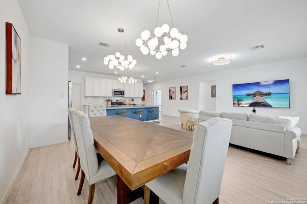 Chandelier, Dining room, Interior, Kitchen, Living room, Pendant Lights, Recessed Lighting, Stainless Steel Appliances, Wood Texture Flooring