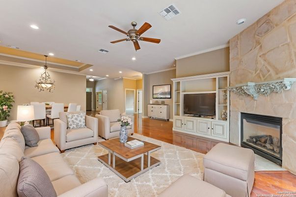Chandelier, Dining room, Fireplace, Interior, Living room, Pendant Lights, Recessed Lighting, Stone Walls, Wood Texture Flooring