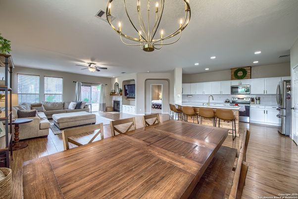 Chandelier, Dining room, Fireplace, Interior, Kitchen, Living room, Recessed Lighting, Stainless Steel Appliances, Wood Texture Flooring
