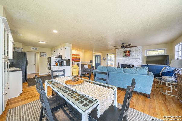 Dining room, Fireplace, Interior, Kitchen, Living room, Recessed Lighting, Stone Walls, Wood Texture Flooring