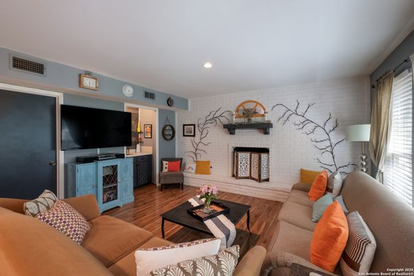 Fireplace, Interior, Living room, Recessed Lighting, Stone Walls, Wood Texture Flooring