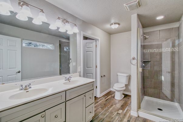 Bathroom, Dual Sink Vanities, Glass Shower, Interior, Recessed Lighting, Wood Texture Flooring