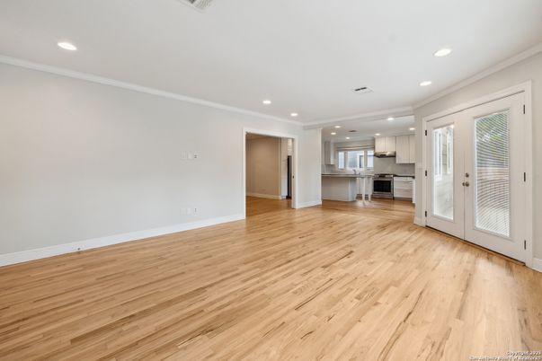 Empty room, Interior, Kitchen, Recessed Lighting, Stainless Steel Appliances, Wood Texture Flooring