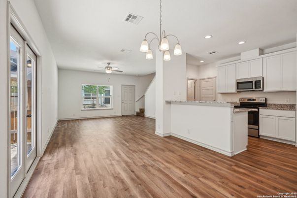 Chandelier, Empty room, Interior, Kitchen, Recessed Lighting, Stainless Steel Appliances, Wood Texture Flooring