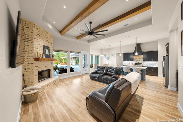 Fireplace, Interior, Kitchen, Living room, Pendant Lights, Recessed Lighting, Stainless Steel Appliances, Stone Walls, Wooden Beams, Wood Texture Flooring