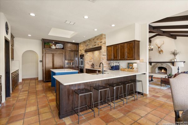 Fireplace, Interior, Kitchen, Recessed Lighting, Stainless Steel Appliances, Stone Walls, Wooden Beams