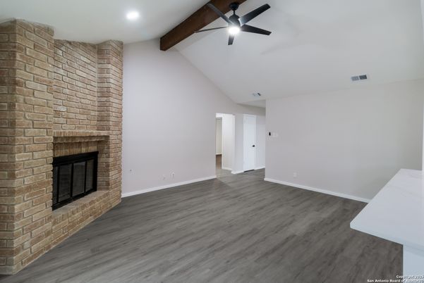 Empty room, Fireplace, Interior, Recessed Lighting, Stone Walls, Wooden Beams, Wood Texture Flooring