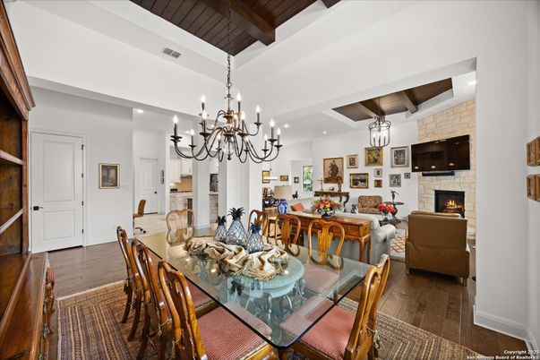 Chandelier, Dining room, Fireplace, Interior, Living room, Recessed Lighting, Stone Walls, Wooden Beams, Wooden Ceilings, Wood Texture Flooring