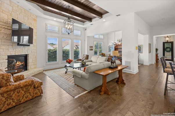 Chandelier, Fireplace, Interior, Living room, Pendant Lights, Recessed Lighting, Stone Walls, Wooden Beams, Wooden Ceilings, Wood Texture Flooring