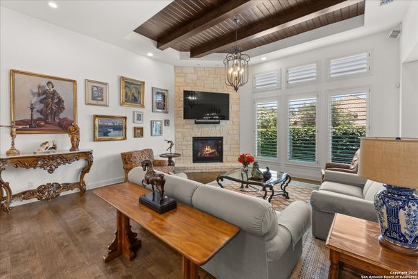 Chandelier, Fireplace, Interior, Living room, Recessed Lighting, Stone Walls, Wooden Beams, Wooden Ceilings, Wood Texture Flooring
