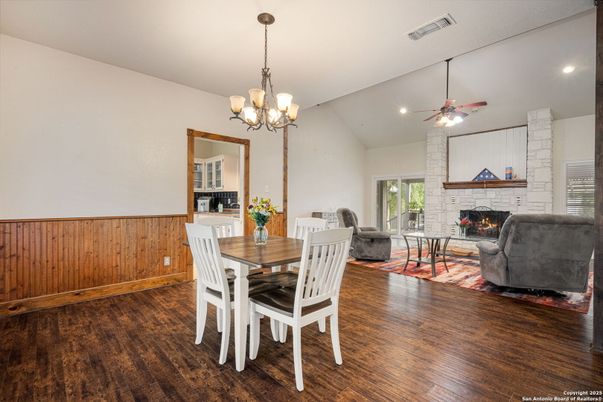 Chandelier, Dining room, Fireplace, Interior, Living room, Recessed Lighting, Stone Walls, Wood Texture Flooring