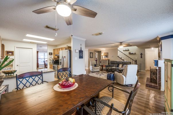 Dining room, Fireplace, Interior, Kitchen, Living room, Recessed Lighting, Stainless Steel Appliances, Wood Texture Flooring